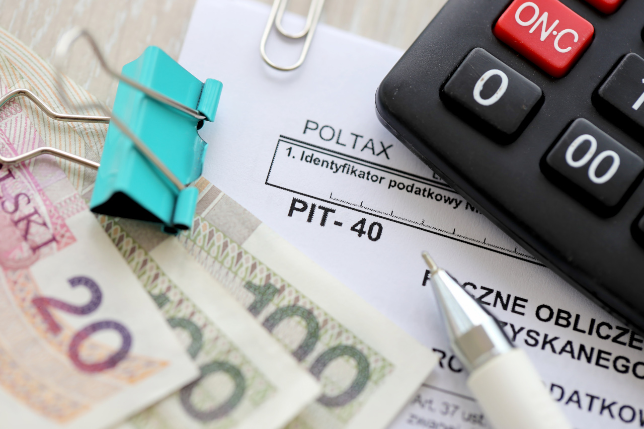 Annual calculation of tax on income obtained by taxpayer, PIT-40 tax forms on accountant table with pen and polish zloty money bills