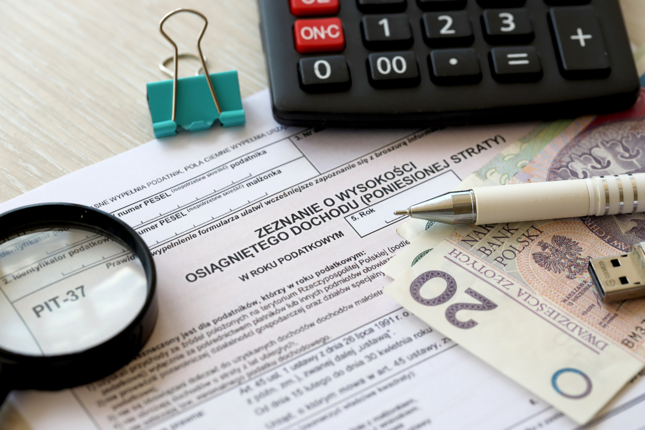 Declaration of the amount of earned income or incurred loss PIT-37 tax forms on accountant table with pen and polish zloty money bills